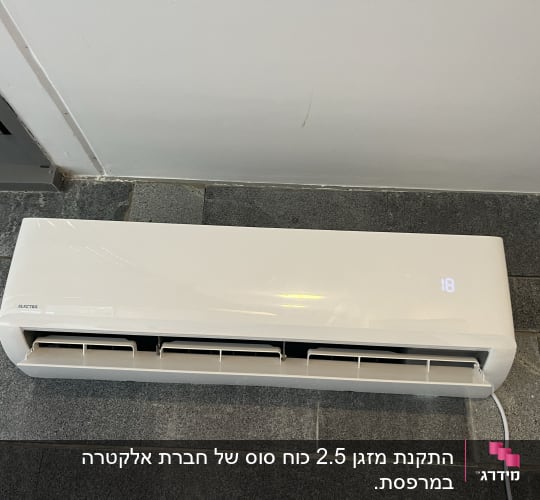 מזגן קיר לבן עם תצוגת טמפרטורה דיגיטלית